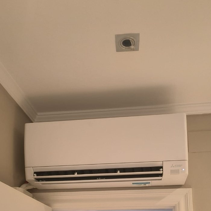 Mitsubishi Electric wall split above a sliding door, installed by JAG Alcaide
