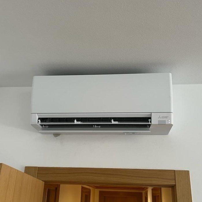 Mitsubishi Electric wall split above a door, installed by JAG Alcaide