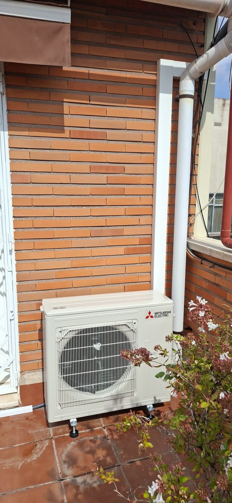 Mitsubishi Electric air conditioning outdoor unit on a terrace, installed by JAG Alcaide