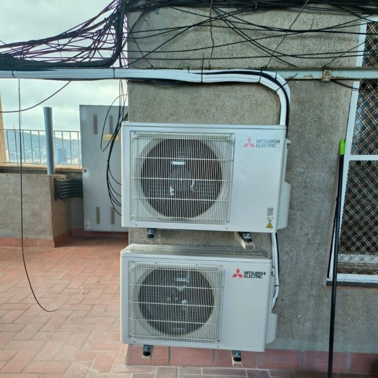 Two Mitsubishi Electric outdoor units on a Barcelona rooftop, installed by JAG Alcaide